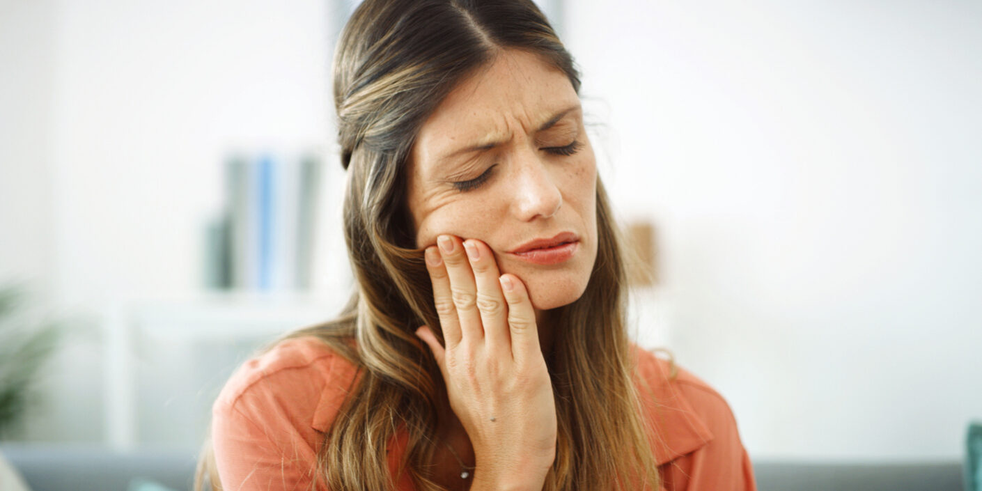 Woman, mouth and pain with toothache at house from dental cavity, tooth extraction and gum infection. Female person, discomfort and decay with gingivitis, root canal injury and treatment for filling